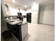 Well-lit kitchen area, featuring an eat-in bar and modern appliances at 11847 Dumaine Valley Rd, Riverview, FL 33579