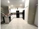 Modern kitchen with a breakfast bar, featuring sleek black appliances and granite countertops at 11847 Dumaine Valley Rd, Riverview, FL 33579