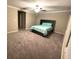 This large bedroom with neutral carpet and walls features a ceiling fan and lots of natural light at 11847 Dumaine Valley Rd, Riverview, FL 33579