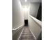 Carpeted staircase with white railing leading to the home's upper level at 11847 Dumaine Valley Rd, Riverview, FL 33579
