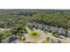 Aerial view of homes situated around a roundabout, surrounded by beautiful mature trees at 12121 Rustic River Way, Tampa, FL 33635