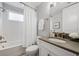 Bathroom with a tub and shower combination, gray vanity and neutral decor at 12121 Rustic River Way, Tampa, FL 33635