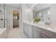 Bright bathroom with double sink vanity, glass shower, and walk in closet at 12121 Rustic River Way, Tampa, FL 33635