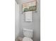 Clean bathroom features shower with curtain, decorative art, white towels, and standard toilet at 12121 Rustic River Way, Tampa, FL 33635