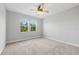 Unfurnished bedroom with carpet floors, a ceiling fan and bright windows at 12121 Rustic River Way, Tampa, FL 33635