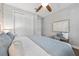 Bright bedroom features hardwood floors, ceiling fan and modern décor at 12121 Rustic River Way, Tampa, FL 33635