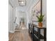 Elegant foyer with hardwood floors, console table with decor, and staircase at 12121 Rustic River Way, Tampa, FL 33635