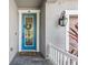 Charming front door with decorative wreath, sidelight, and modern hardware at 12121 Rustic River Way, Tampa, FL 33635
