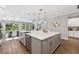 Open kitchen boasts an island with bar seating, stainless steel appliances, and lots of storage at 12121 Rustic River Way, Tampa, FL 33635