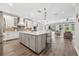 Spacious kitchen featuring a large island, stainless steel appliances, and open floorplan at 12121 Rustic River Way, Tampa, FL 33635