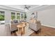 Bright living room with lots of natural light, neutral furniture, and hardwood floors at 12121 Rustic River Way, Tampa, FL 33635