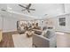 Open-concept living room showcasing a large island kitchen, hardwood floors, and modern furniture at 12121 Rustic River Way, Tampa, FL 33635