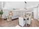Open-concept living and dining area with hardwood floors, an island kitchen, and neutral-colored furniture at 12121 Rustic River Way, Tampa, FL 33635