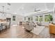 Spacious living area features hardwood floors, neutral furniture, an open concept, and lots of natural light at 12121 Rustic River Way, Tampa, FL 33635