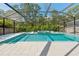 Beautiful pool area with spa, lush landscaping, and plenty of room for entertaining at 12121 Rustic River Way, Tampa, FL 33635