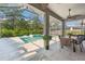 Screened in pool area with spa, outdoor seating and dining area with patio furniture at 12121 Rustic River Way, Tampa, FL 33635