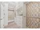 Spacious walk-in closet with custom shelves, drawers, and carpeted floors at 12121 Rustic River Way, Tampa, FL 33635