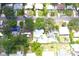 The aerial perspective highlights residential houses with private pools and solar panels among verdant mature trees in this neighborhood at 1317 S Betty Ln, Clearwater, FL 33756