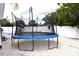 Backyard featuring a blue trampoline in the backyard, surrounded by fresh gravel at 1317 S Betty Ln, Clearwater, FL 33756