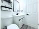 Contemporary bathroom features toilet, vanity with storage, black hardware, and neutral colors at 1317 S Betty Ln, Clearwater, FL 33756