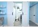 Stylish bathroom with sliding barn doors, wood look flooring, white vanity, and updated fixtures at 1317 S Betty Ln, Clearwater, FL 33756