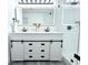Bright bathroom featuring a double sink vanity with sleek black hardware and a glass walk-in shower at 1317 S Betty Ln, Clearwater, FL 33756