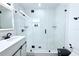 Updated bathroom showcasing a glass-enclosed shower with white textured walls and a modern vanity at 1317 S Betty Ln, Clearwater, FL 33756