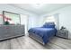 Bright bedroom with dresser, nightstand, and luxury vinyl plank flooring at 1317 S Betty Ln, Clearwater, FL 33756