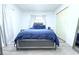 Bedroom features luxury vinyl flooring, white walls, and a window with curtains, and double door closet at 1317 S Betty Ln, Clearwater, FL 33756