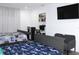 Bright bedroom featuring two beds with colorful dinosaur and video game-themed bedding, TV, and a built-in desk area at 1317 S Betty Ln, Clearwater, FL 33756
