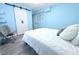 Charming bedroom showcasing a barn door, blue walls, vinyl floors, and minimalist decor at 1317 S Betty Ln, Clearwater, FL 33756