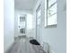 Bright entryway featuring gray vinyl floors, white walls, and natural light from the front door windows at 1317 S Betty Ln, Clearwater, FL 33756