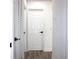 Hallway featuring white doors, baseboards and vinyl flooring at 1317 S Betty Ln, Clearwater, FL 33756