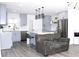 Stylish kitchen with gray cabinets, stainless steel appliances, and an island with bar stool seating at 1317 S Betty Ln, Clearwater, FL 33756