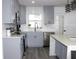 Modern kitchen featuring gray cabinets, stainless steel appliances, and a tiled backsplash at 1317 S Betty Ln, Clearwater, FL 33756
