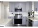 Well-equipped kitchen with gray cabinets, stainless steel appliances, and modern fixtures at 1317 S Betty Ln, Clearwater, FL 33756