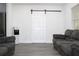 Cozy living room with a sliding barn door, comfortable seating and natural light at 1317 S Betty Ln, Clearwater, FL 33756