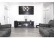 Modern living room featuring a TV and an electric fireplace under, and gray couches at 1317 S Betty Ln, Clearwater, FL 33756