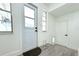 Mud room featuring tile floor, a window, an exterior door, and a white interior door with pet door at 1317 S Betty Ln, Clearwater, FL 33756