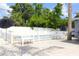 View of the backyard pool, privacy fence, patio, and green space at 1317 S Betty Ln, Clearwater, FL 33756