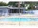 A private swimming pool with white picket fence, perfect for relaxation and entertainment at 1317 S Betty Ln, Clearwater, FL 33756