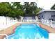 Inviting backyard pool, perfect for relaxation and entertainment, with a white fence and brick trim at 1317 S Betty Ln, Clearwater, FL 33756