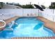 Inviting swimming pool with brown brick edging, complete with an inflatable dolphin at 1317 S Betty Ln, Clearwater, FL 33756
