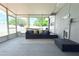 Enclosed patio with outdoor seating, a ceiling fan, and views of the fenced-in pool and backyard at 1317 S Betty Ln, Clearwater, FL 33756