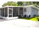 Enclosed porch with outdoor furniture, patio, and view of fenced-in yard at 1317 S Betty Ln, Clearwater, FL 33756