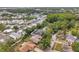 Property showcasing a serene residential street, mature trees, and well-maintained neighboring homes at 1363 Cottage Grove Rd, Tarpon Springs, FL 34689