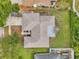 An aerial view of a home displaying its roof, yard, and neighboring properties in a suburban area at 1363 Cottage Grove Rd, Tarpon Springs, FL 34689
