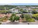 This aerial view showcases the property's mature trees, manicured front lawn, and street appeal in a serene neighborhood at 1363 Cottage Grove Rd, Tarpon Springs, FL 34689