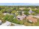 Property featuring a well-maintained exterior, complemented by mature trees, and a tranquil residential neighborhood setting at 1363 Cottage Grove Rd, Tarpon Springs, FL 34689