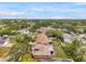 Residence boasting a serene backyard setting, attractive exterior design, and mature shade trees at 1363 Cottage Grove Rd, Tarpon Springs, FL 34689
